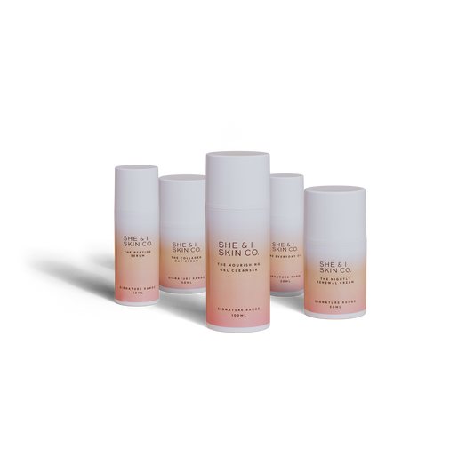 She & I Skin Co. skincare collection featuring cleansers, creams, and serums in sleek white-to-pink gradient packaging, perfect for a nourishing and luxurious skincare routine.