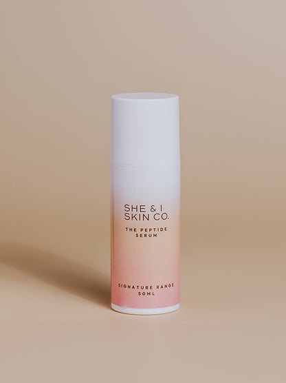 She & I Skin Co. "The Peptide Serum," 50ml, designed to enhance skin hydration and smoothness. Sleek gradient white-to-pink packaging displayed on a minimalist beige background.