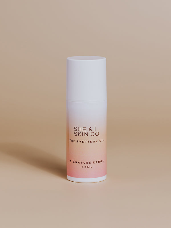  She & I Skin Co. "The Everyday Oil," 30ml, featuring sleek gradient packaging from white to pink. Perfect for daily hydration and nourishment, presented on a minimalist beige background.