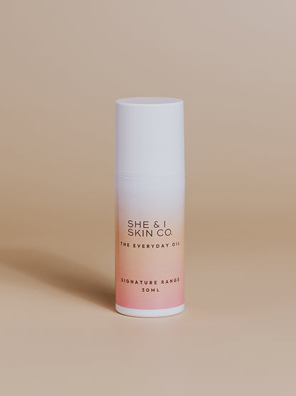  She & I Skin Co. "The Everyday Oil," 30ml, featuring sleek gradient packaging from white to pink. Perfect for daily hydration and nourishment, presented on a minimalist beige background.