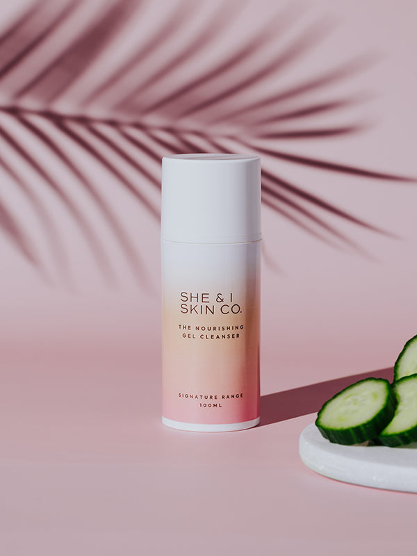 She & I Skin Co. "The Nourishing Gel Cleanser," 100ml, highlighted with fresh cucumber slices and tropical palm shadows, emphasising its refreshing and hydrating properties.