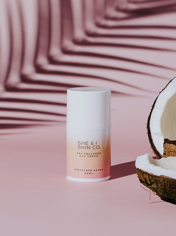 She & I Skin Co. "The Collagen Day Cream," 50ml, featured with a halved coconut and tropical palm shadows, highlighting its hydrating and refreshing qualities for radiant skin.