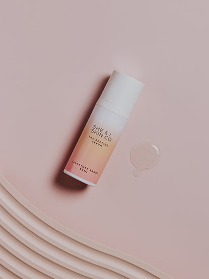 She & I Skin Co. "The Peptide Serum," 50ml, highlighted with a clear serum droplet on a soft pink background. Perfect for achieving hydrated, youthful skin.